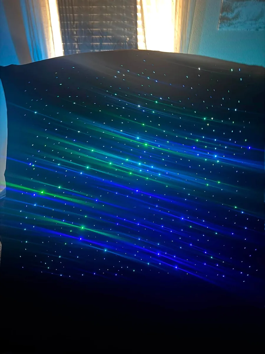 Headliner panel with shooting-star fiber runs streaking across the star field