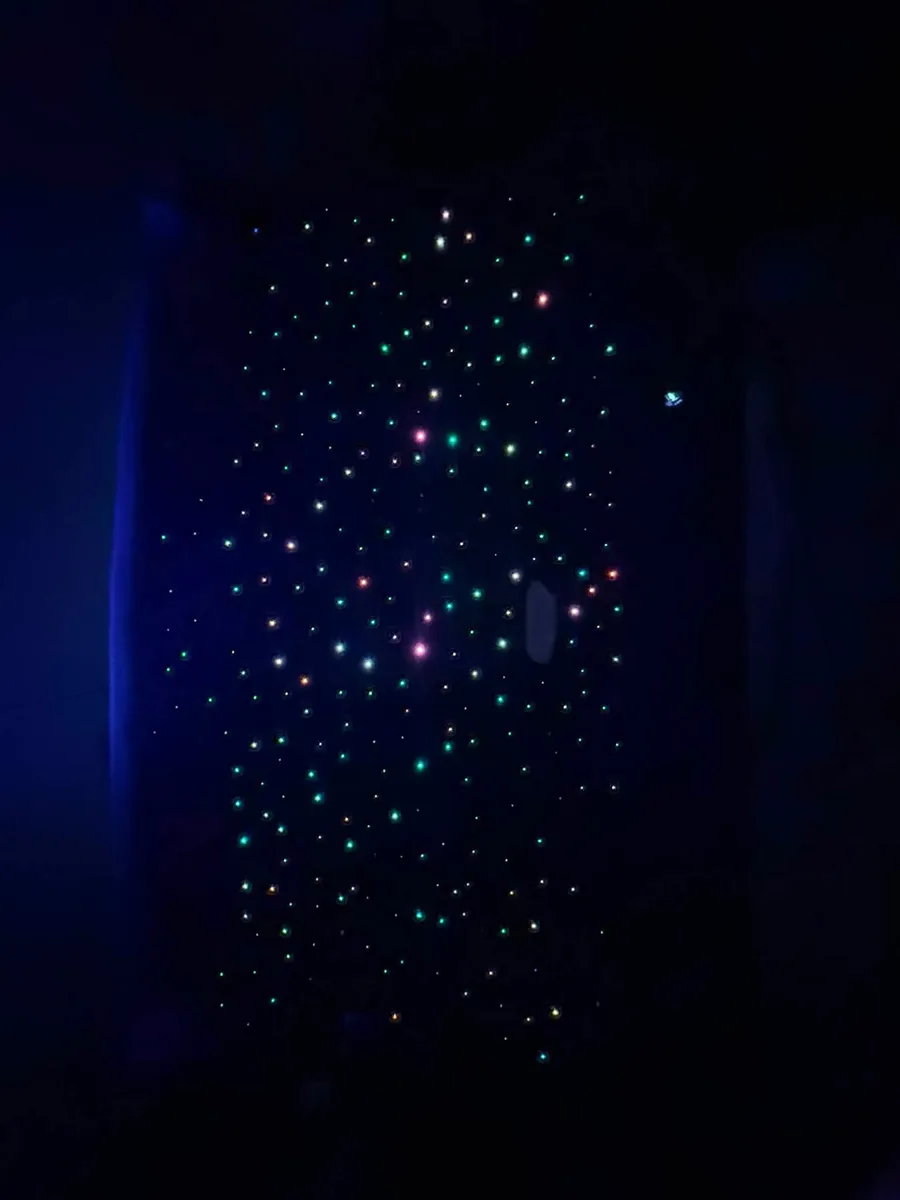 Finished starlight headliner panel lit in a dark room